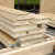 A photo of a stack of cut SIPs panels on a building site