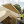 A photo of a SIPs roof panel being craned onto a build frame